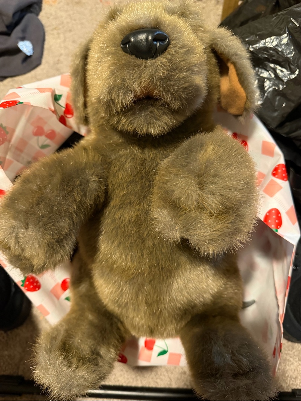 a Folkmanis Sitting Dog Hand Puppet featuring soft brown plush fur